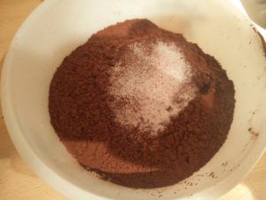 The salt and baking soda sprinkled on top of the coca flour mix