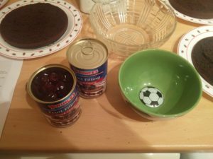 A can full of cherries and an empty bowl