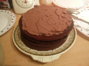 The top layer of the cake has been covered in the whipped cream