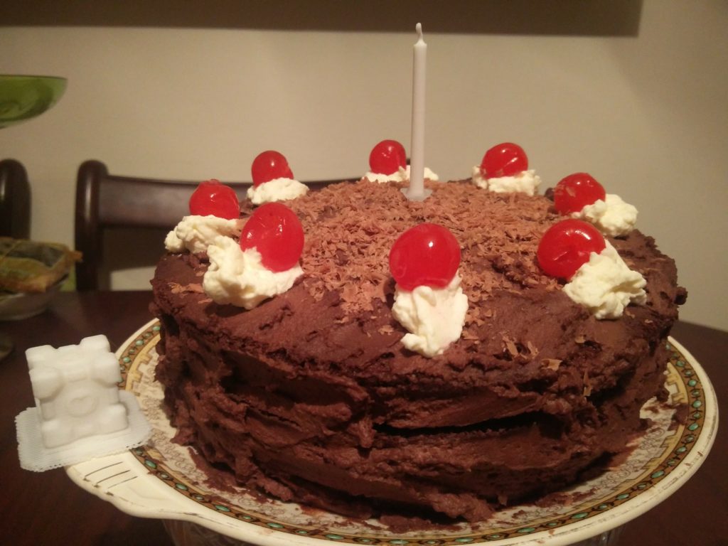 The completed Portal Cake, with a Companion Cube next to it