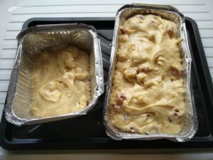 The cherry cake mix poured into the cake tins