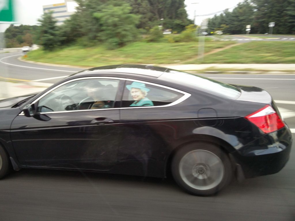 A photo of the queen in the back of a car